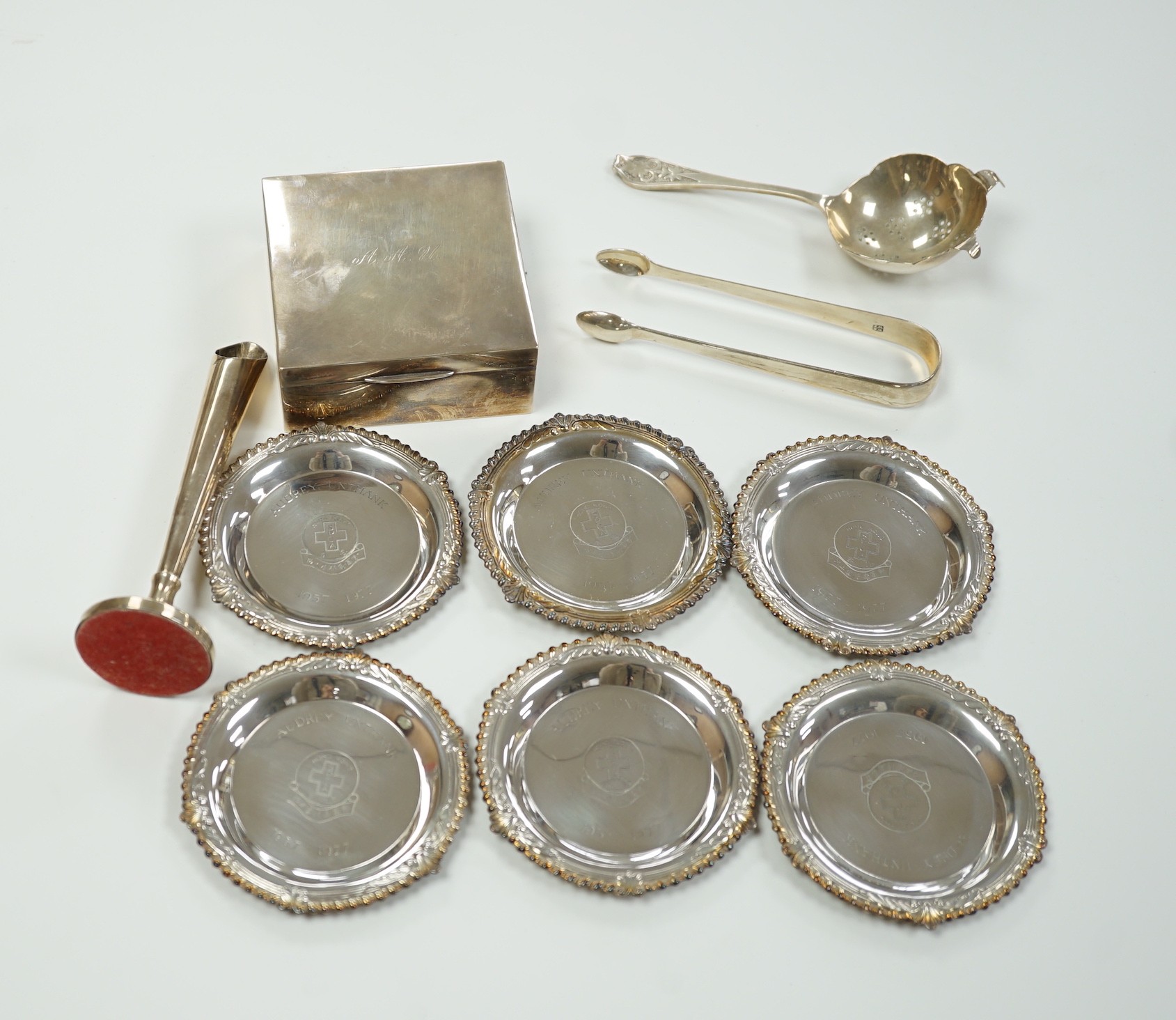 A Chinese sterling mounted cigarette box by Wai Kee, 92mm, a set of six modern silver small dishes, a silver tea strainer, par of Georgian silver sugar tongs and a modern silver mounted posy vase.
